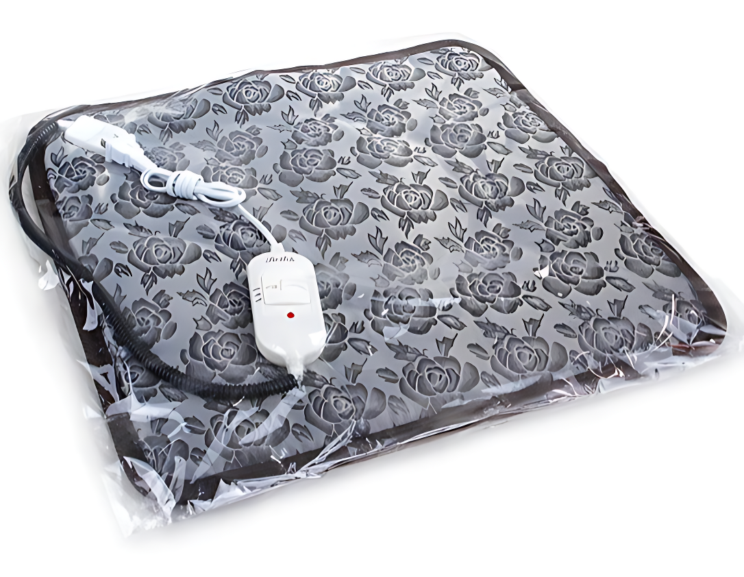 Heating pad with floral pattern and control switch on a white background
